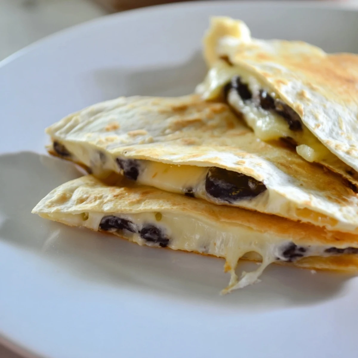 Delicious homemade bean and cheese quesadillas, showcasing a quick and easy recipe for everyone.