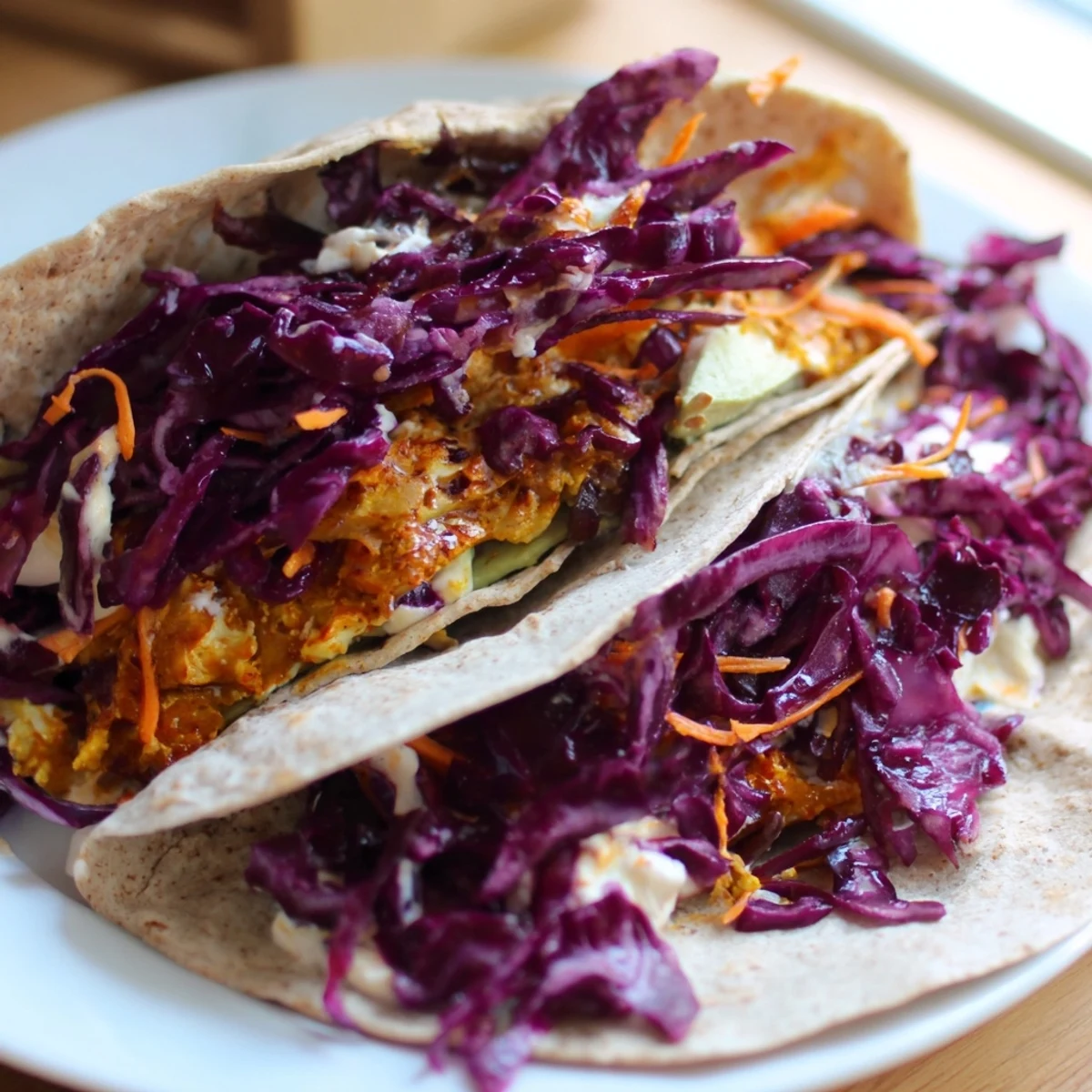 BBQ Chickpea & Slaw Holiday Wrap, bursting with colorful slaw and smoky, plant-based chickpeas, ready to eat!