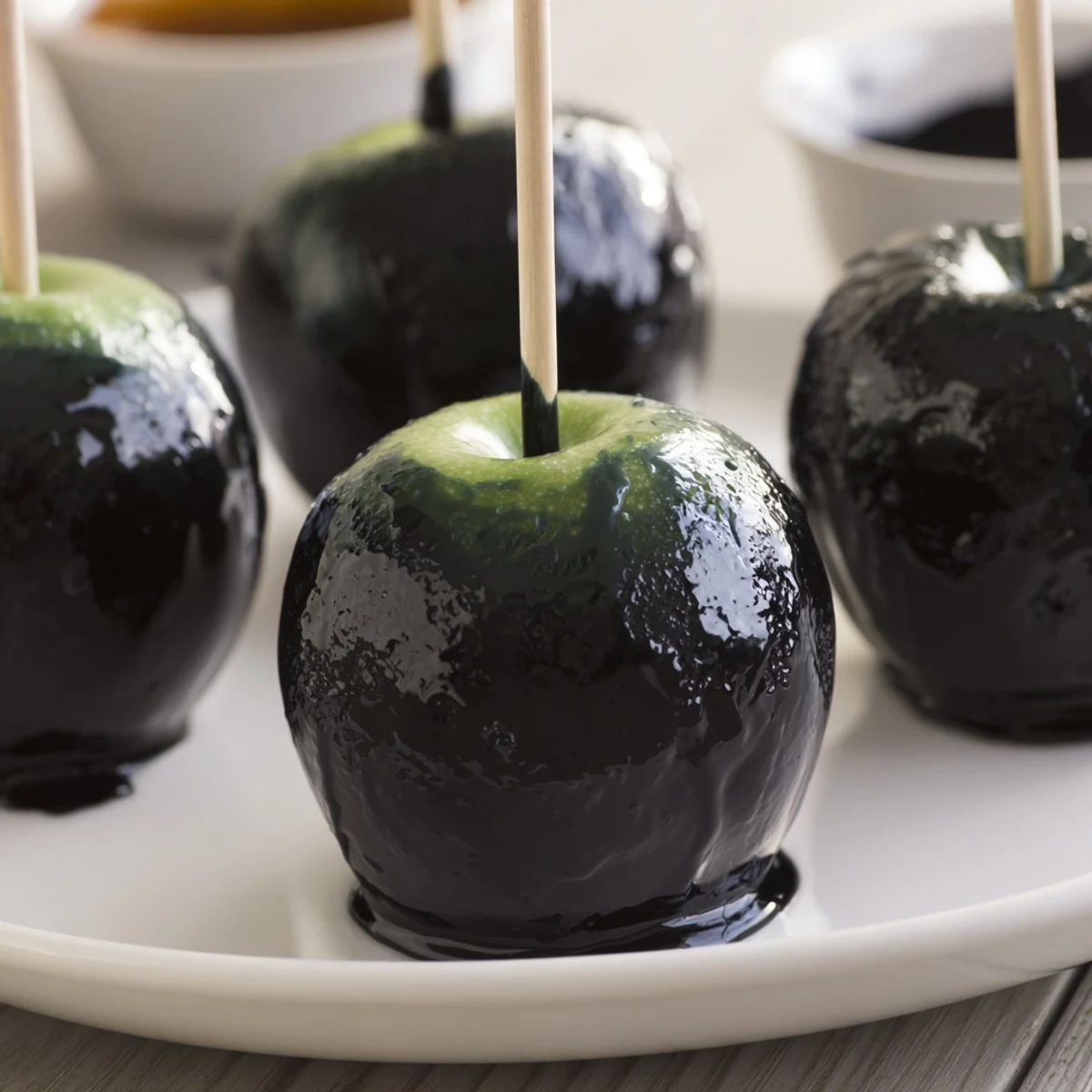 Vibrant overhead shot of a Poison Apple Halloween treat board, overflowing with dark, delicious party foods.