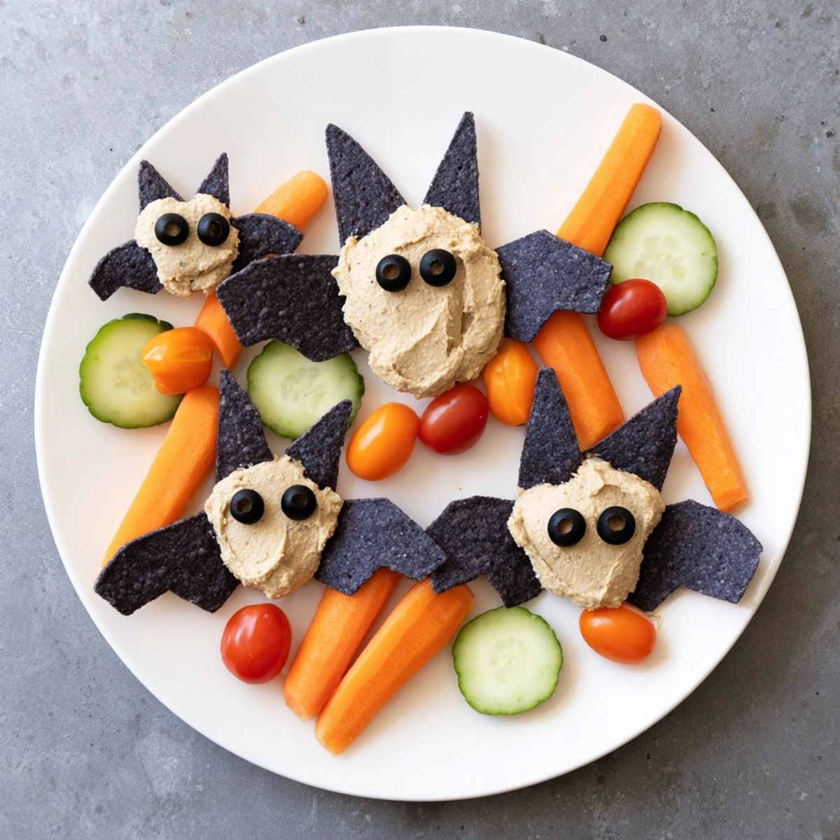 Creamy Spooky Bat Bean Dip Platter, a festive Halloween appetizer with black bean bats and veggies.