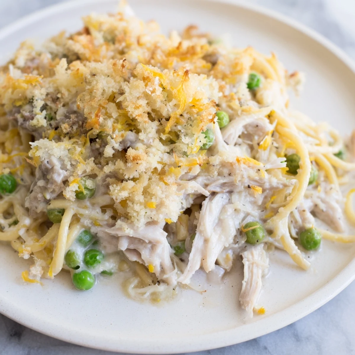 A delicious, creamy Turkey or Chicken Tetrazzini, featuring tender chicken and a crispy parmesan topping.