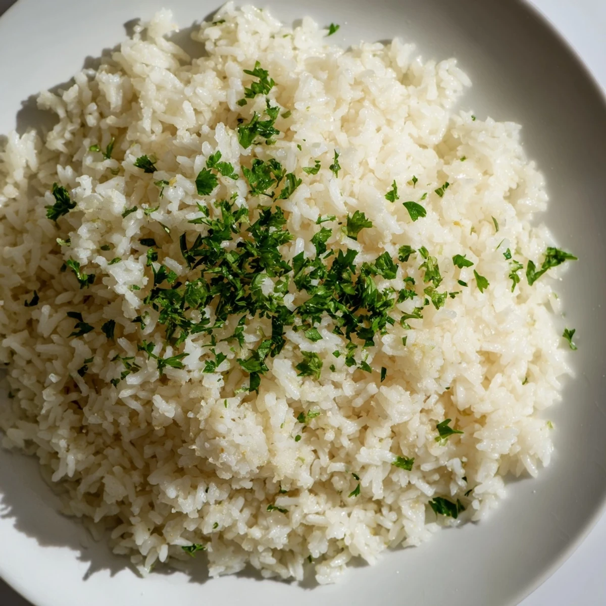 A close-up view of Garlic Butter Rice, each grain glistening, suggesting a delicious side dish made with garlic.