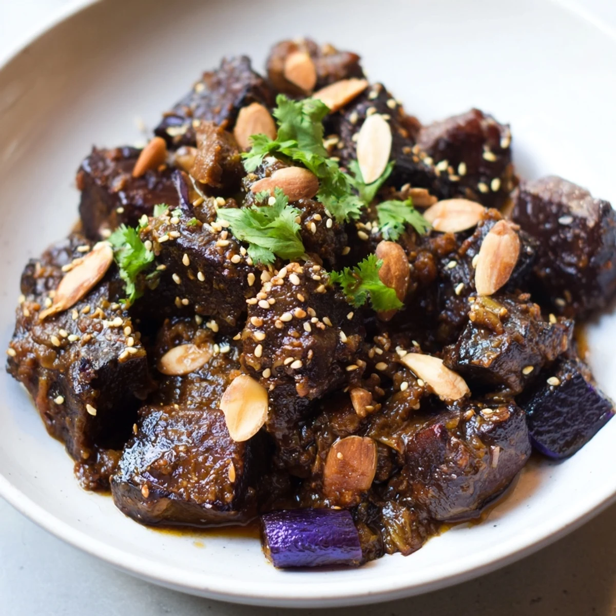 Savory Moroccan Lamb Tagine, richly flavored with prunes and almonds, simmering in a spiced sauce.
