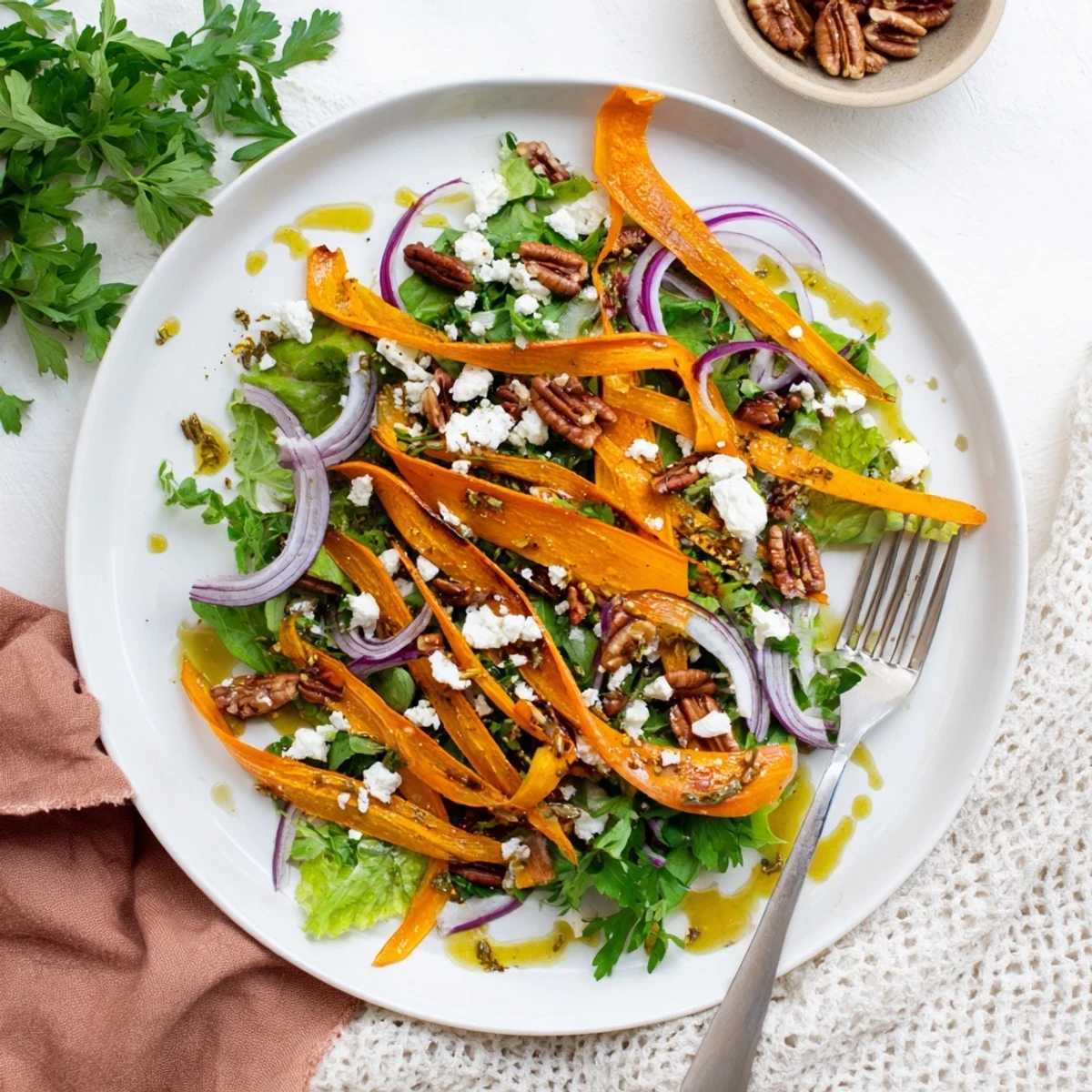 Vibrant orange carrot ribbons roasted to caramelized perfection, layered over greens and finished with feta.