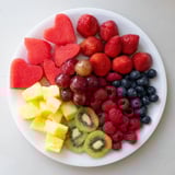 Vibrant sweetheart fruit board arranged into a heart shape, showcasing colorful, fresh pieces.