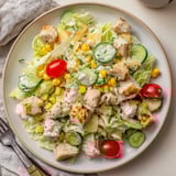 Ranch Chicken Chopped Salad served in a bright bowl, featuring crisp romaine, juicy tomatoes, and a tangy herb dressing.  