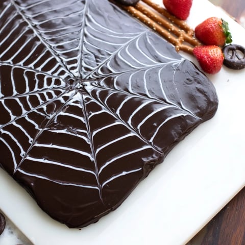 Halloween Spiderweb Chocolate Ganache Board with fresh fruit and dippable sweets for sharing.