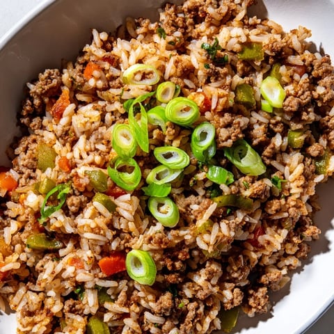 Cajun Dirty Rice: A steaming bowl of flavorful rice with savory meats and vibrant vegetables.