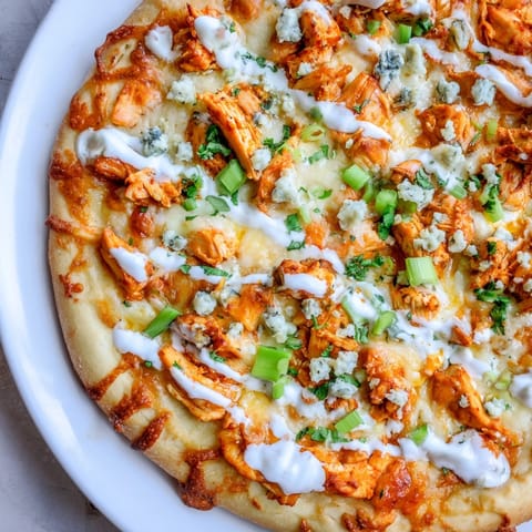 Hot, cheesy Buffalo Chicken Pizza with crispy crust, ready to serve for dinner.
