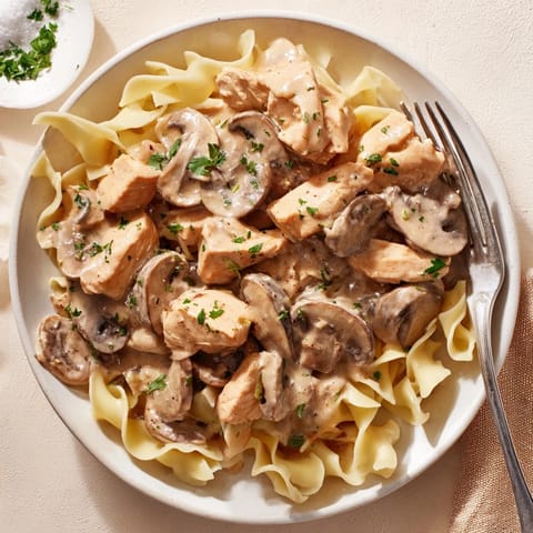 Delicious Creamy Chicken Stroganoff garnished with fresh parsley, perfect for comforting dinners.  