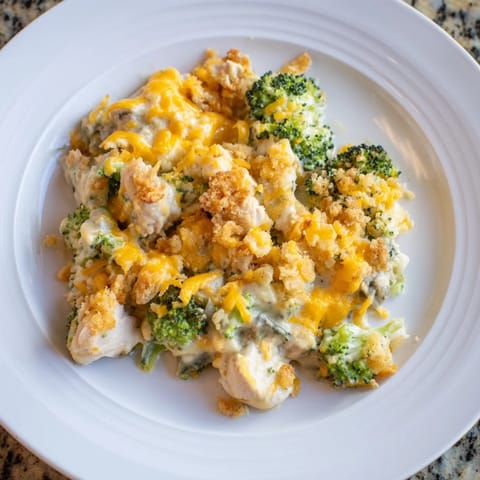 A close-up view of the creamy, cheesy Cheddar Broccoli Chicken Bake with broccoli florets and tender chicken.