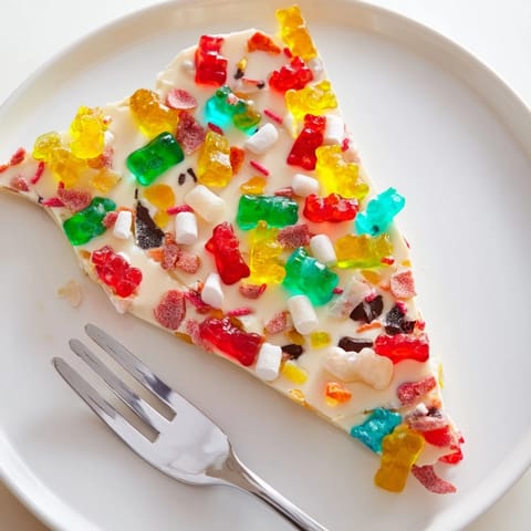 Colorful array of Gummy Bears and Candy Canes atop a cooling sheet of melted white chocolate.