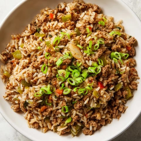 This rustic Cajun Dirty Rice features fluffy rice, tender meats, and a kick of Cajun spice for dinner.
