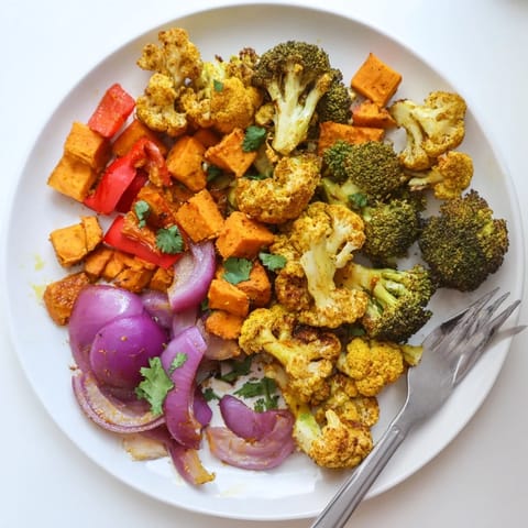 Serving Anti-Inflammatory Turmeric Roasted Vegetables alongside lemon wedges and fresh cilantro for a zesty, wellness-boosting side dish.