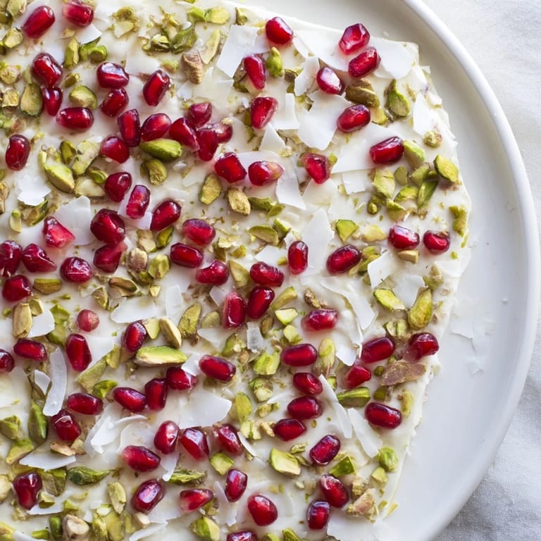 Homemade frozen yogurt bark, sprinkled with pistachios, shows a delicious, healthy dessert option.