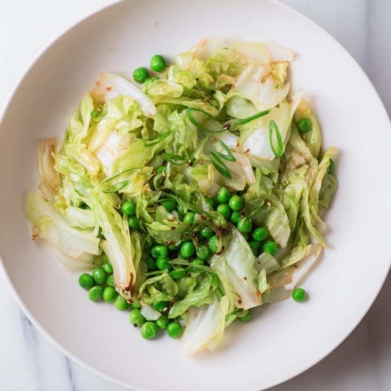 Ready-to-eat Cabbage Stir-Fry with savory garlic, soy, and tender green peas; a perfect side.