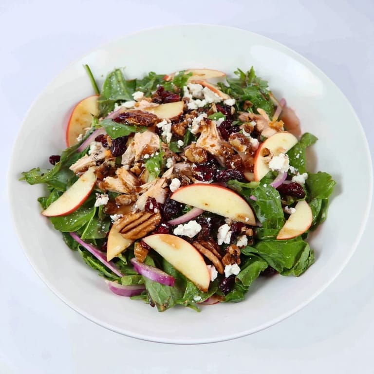 A colorful bowl displays this Chicken and Apple Winter Salad, ready to enjoy on a chilly day.
