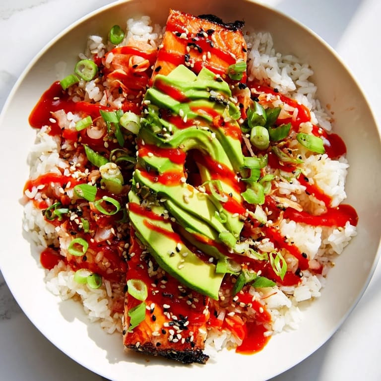 A vibrant bowl of Classic Salmon Rice, enhanced with creamy avocado and toasted sesame seeds.