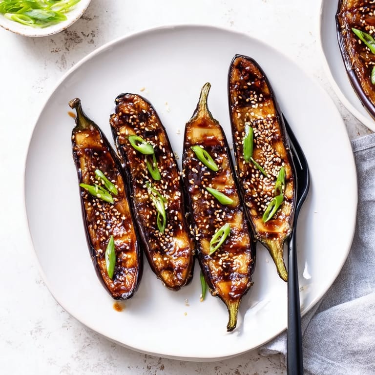 Tender roasted miso glazed eggplant with a caramelized, glossy glaze, served warm as a savory Japanese side dish.