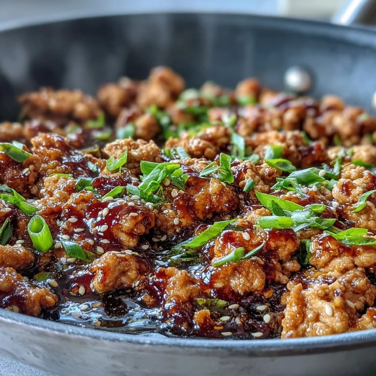 Forkful of savory Korean-Style Ground Turkey featuring ground turkey, minced garlic, ginger, and toasted sesame seeds for a nutty finish.